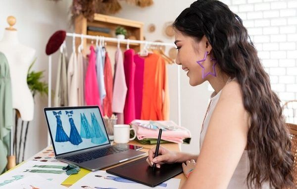 tiendas de diseño de modas en CDMX - Joven diseñadora trabaja en los bocetos de un par de vestidos
