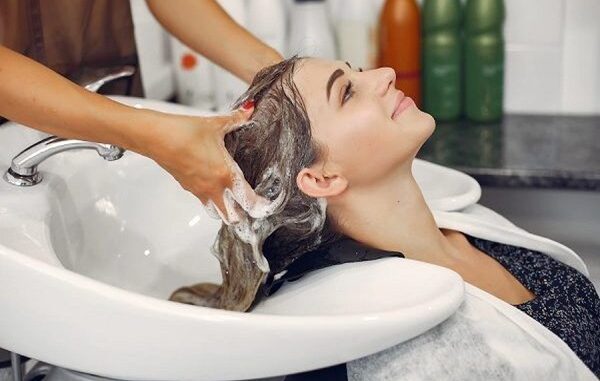 Peluquerías de CDMX - Estilista lavando el cabello de una mujer en una de las mejores peluquerías de CDMX