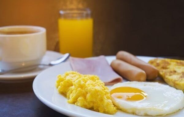 Desayunar - Huevos revueltos, jamón, salchichas y jugo de naranja servido en uno de los mejores lugares para desayunar en CDMX
