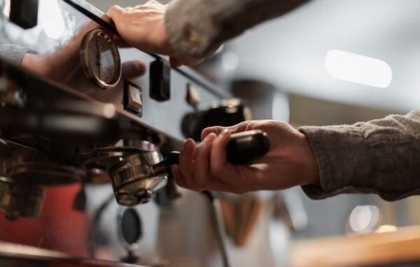 Mejores cafeterías - Barista manipula una máquina de hacer café en una de las mejores cafeterías de CDMX