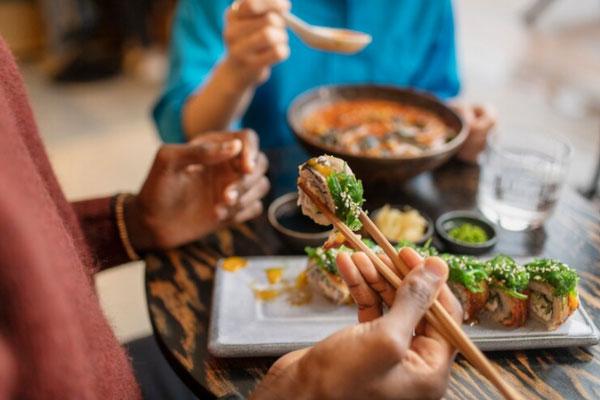 Pareja disfruta de platos típicos de la gastronomía coreana en las instalaciones de un restaurante
